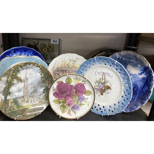 468 - A collection of hanging wall plates and a glass plaque