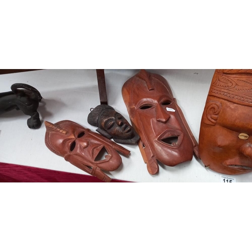 115 - 7 Carved wooden tribal face masks