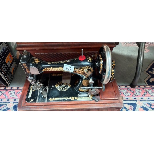 162 - A cased Singer sewing machine COLLECT ONLY