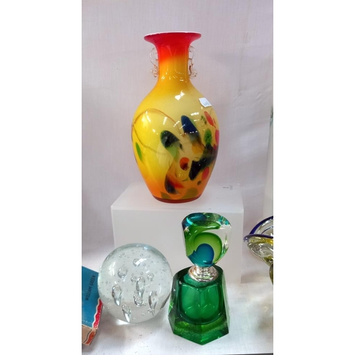 77 - A selection of vintage coloured art glass including scene bottle vases etc