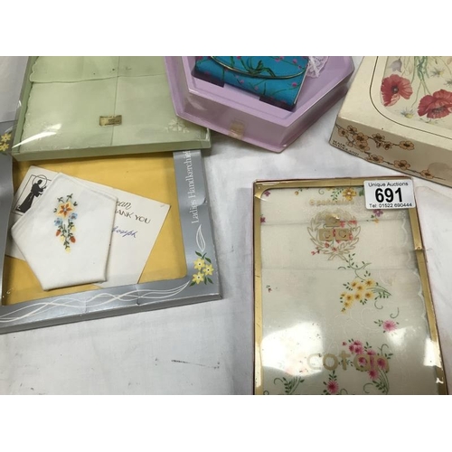 691 - Ladies handkerchiefs, soaps and a poppy dressing table set