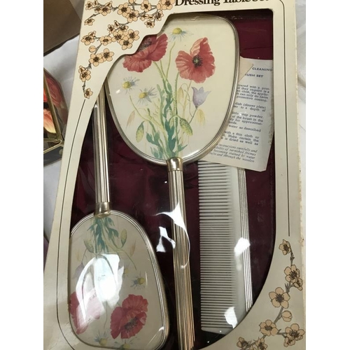 691 - Ladies handkerchiefs, soaps and a poppy dressing table set