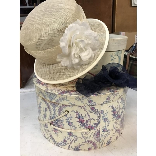 697 - 2 ornate hat boxes with hat and fascinator