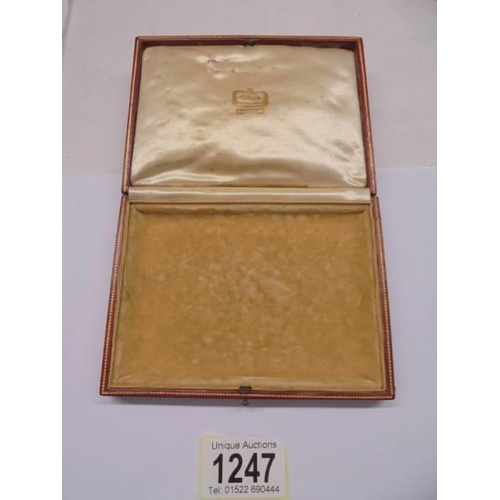 1247 - A vintage red Cartier jewellery box (leather slightly worn in places and missing on back by hinge).