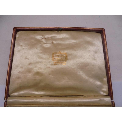 1247 - A vintage red Cartier jewellery box (leather slightly worn in places and missing on back by hinge).