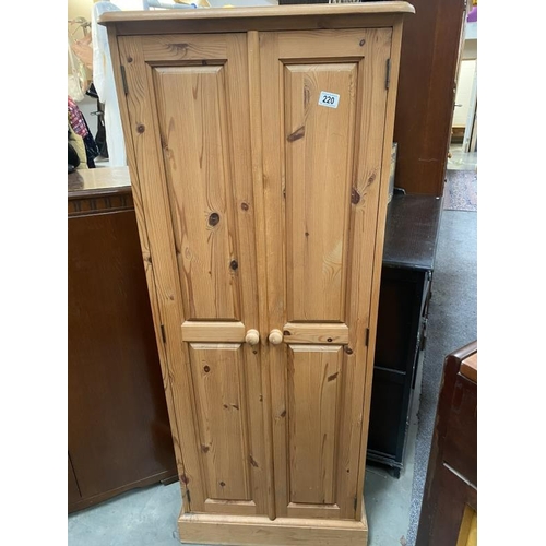 220 - A pine 2 door cupboard (61cm x 34cm x 153cm) COLLECT ONLY