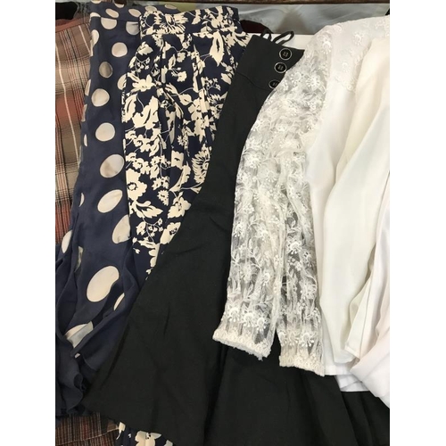 738 - A large quantity of ladies clothing including skirts, shirts and waistcoats