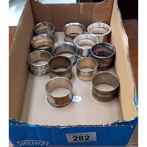 282 - 11 Silver plated napkin rings & 1 Silver