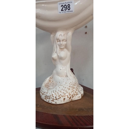 298 - A Jersey pottery figure of a Mermaid holding a shell