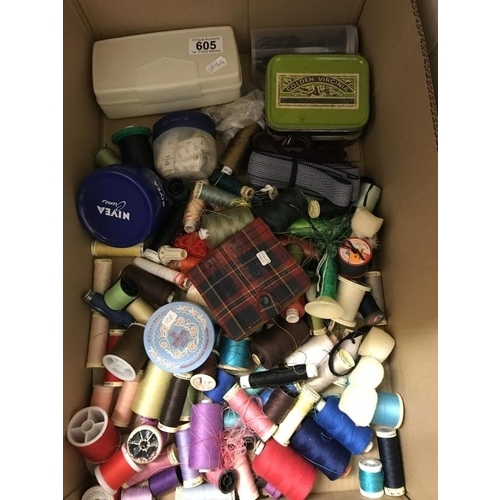 605 - A quantity of sewing items including books, sewing machine feet, buttons, pins etc