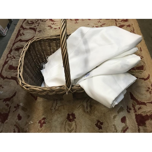 754 - Two wicker baskets and quantity of curtains. White with blue flower