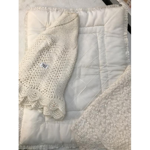 762 - A quantity of knitted blankets and 1 small baby pram cover