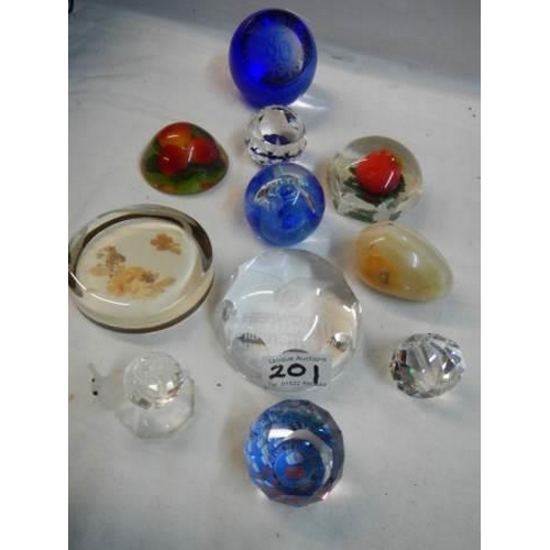 201 - Eleven assorted glass paperweights.