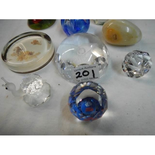 201 - Eleven assorted glass paperweights.