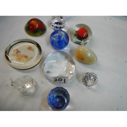 201 - Eleven assorted glass paperweights.