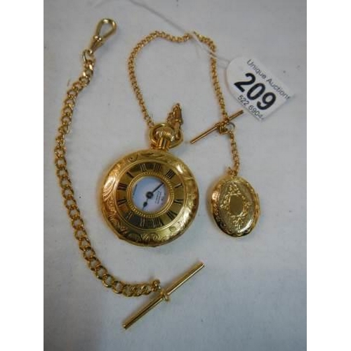 209 - A gold coloured half hunter pocket watch with chain.