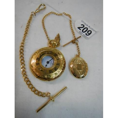 209 - A gold coloured half hunter pocket watch with chain.