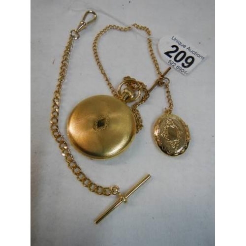 209 - A gold coloured half hunter pocket watch with chain.