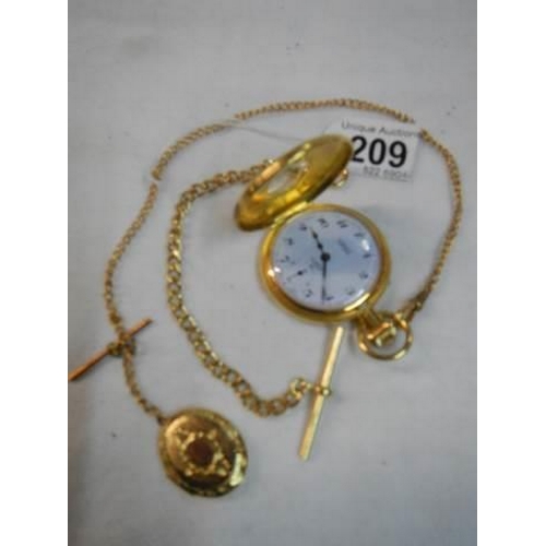 209 - A gold coloured half hunter pocket watch with chain.