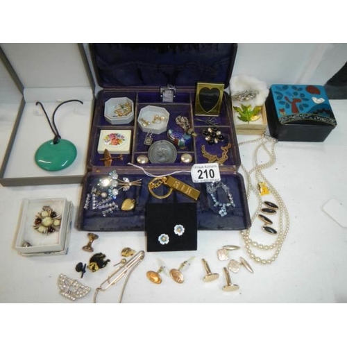 210 - An unusual jewellery box with a mixed lot of costume jewellery.