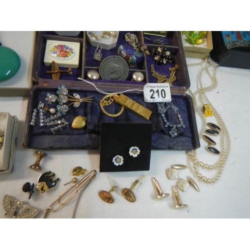 210 - An unusual jewellery box with a mixed lot of costume jewellery.