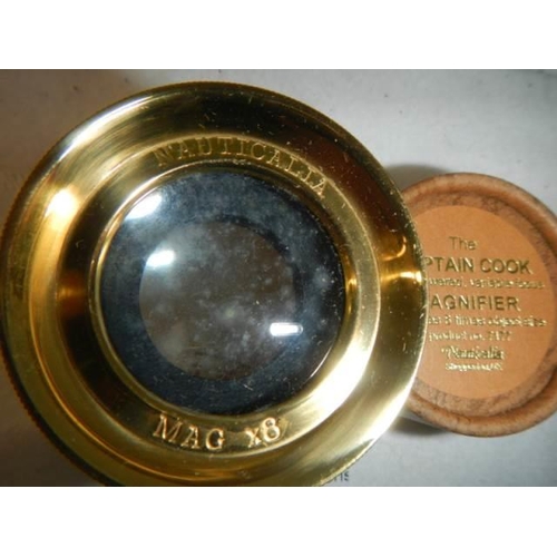 215 - A leather cased 'The Captain Cook' magnifier.