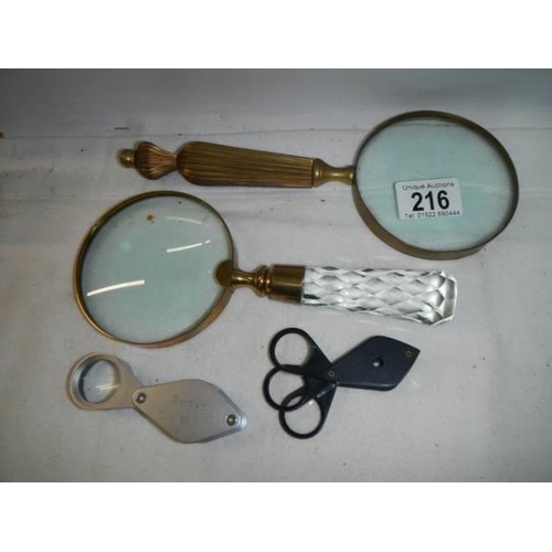 216 - Two 20th century magnifying glasses and two others.