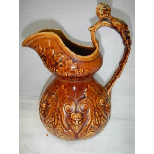 221 - A good early 20th century crackle glaze jug with figural handle.