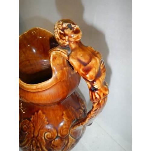 221 - A good early 20th century crackle glaze jug with figural handle.