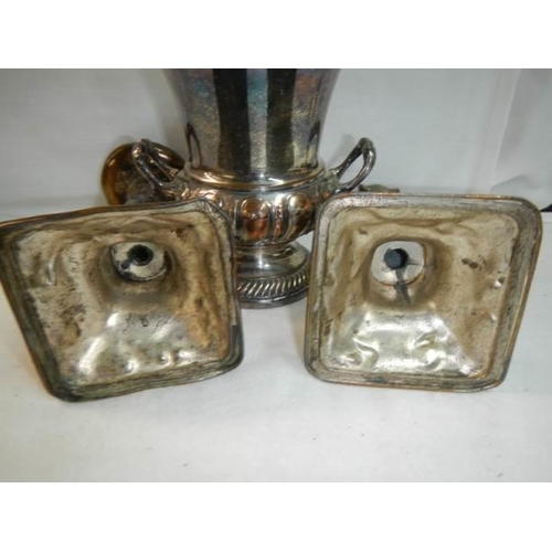 222 - A pair of early 20th century plated candlesticks and a twin handled urn.