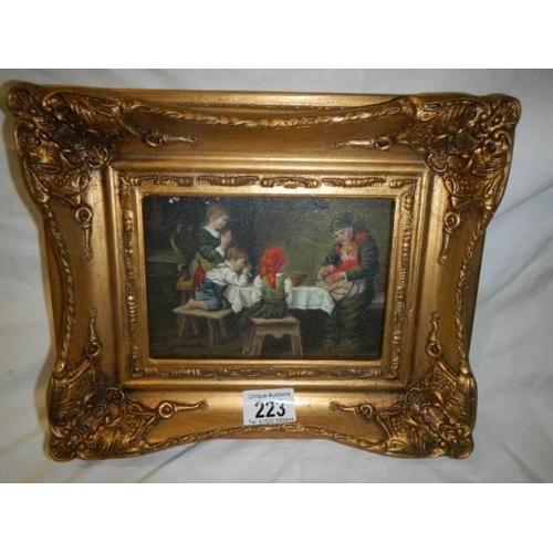 223 - A gilt framed dining room scene.