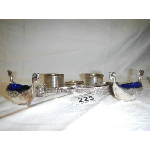 225 - Three silver napkin rings, two plated salts with blue glass linings and a pair of sugar nips.