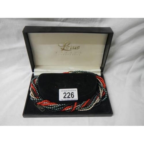 226 - A boxed multi coloured necklace.