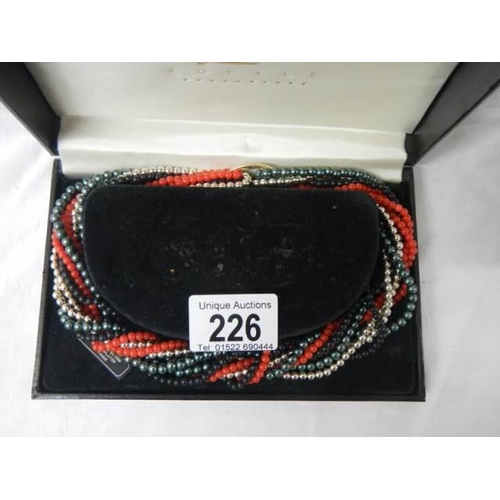 226 - A boxed multi coloured necklace.