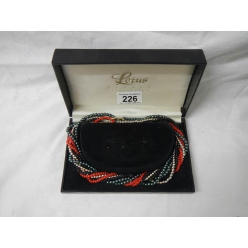 226 - A boxed multi coloured necklace.