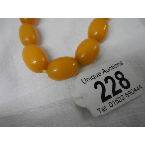 228 - An old amber coloured necklace.