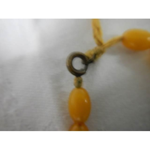 228 - An old amber coloured necklace.