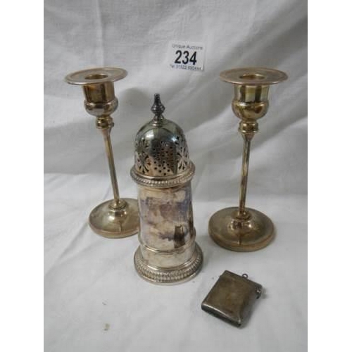 234 - A pair of silver plate candlesticks, sugar sifter and match box.