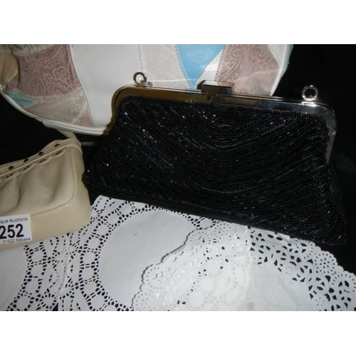 252 - A shoulder bag and two evening bags.