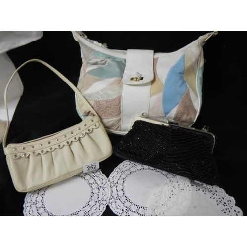 252 - A shoulder bag and two evening bags.