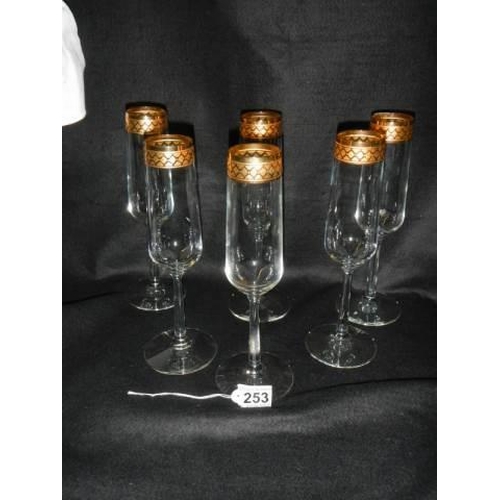 253 - A set of six champagne flutes.