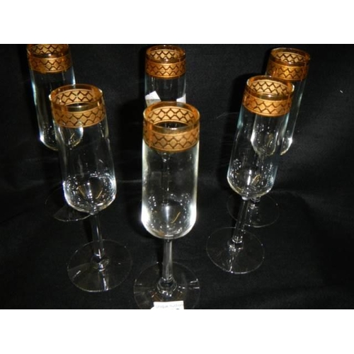 253 - A set of six champagne flutes.