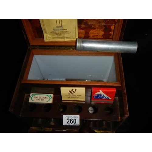 260 - A mahogany smokers box with pipes and cigars etc.,