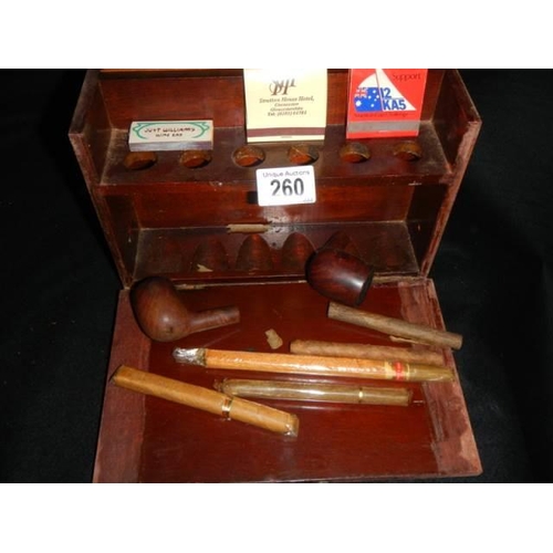 260 - A mahogany smokers box with pipes and cigars etc.,