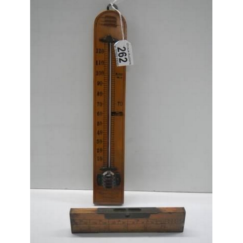 262 - A vintage thermometer and spirit level.