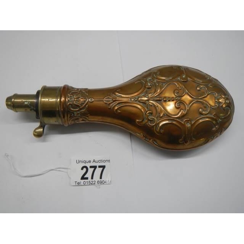 277 - A Victorian copper gunpowder flask (damage to top spring otherwise in good condition).