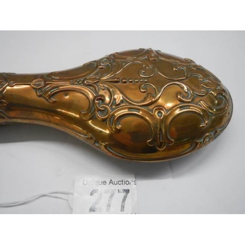 277 - A Victorian copper gunpowder flask (damage to top spring otherwise in good condition).