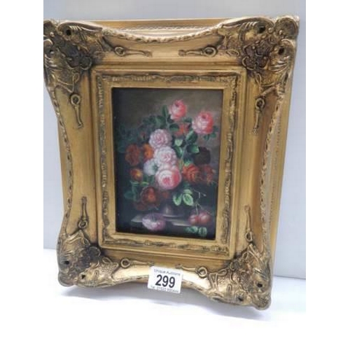 299 - A gilt framed floral display.