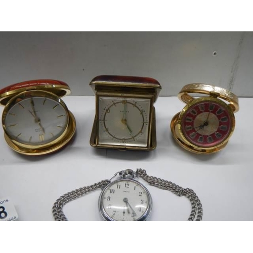 318 - A Smith's pocket watch in working order, 3 other clocks and a pocket watch case,.