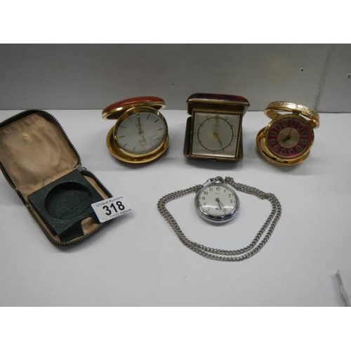 318 - A Smith's pocket watch in working order, 3 other clocks and a pocket watch case,.